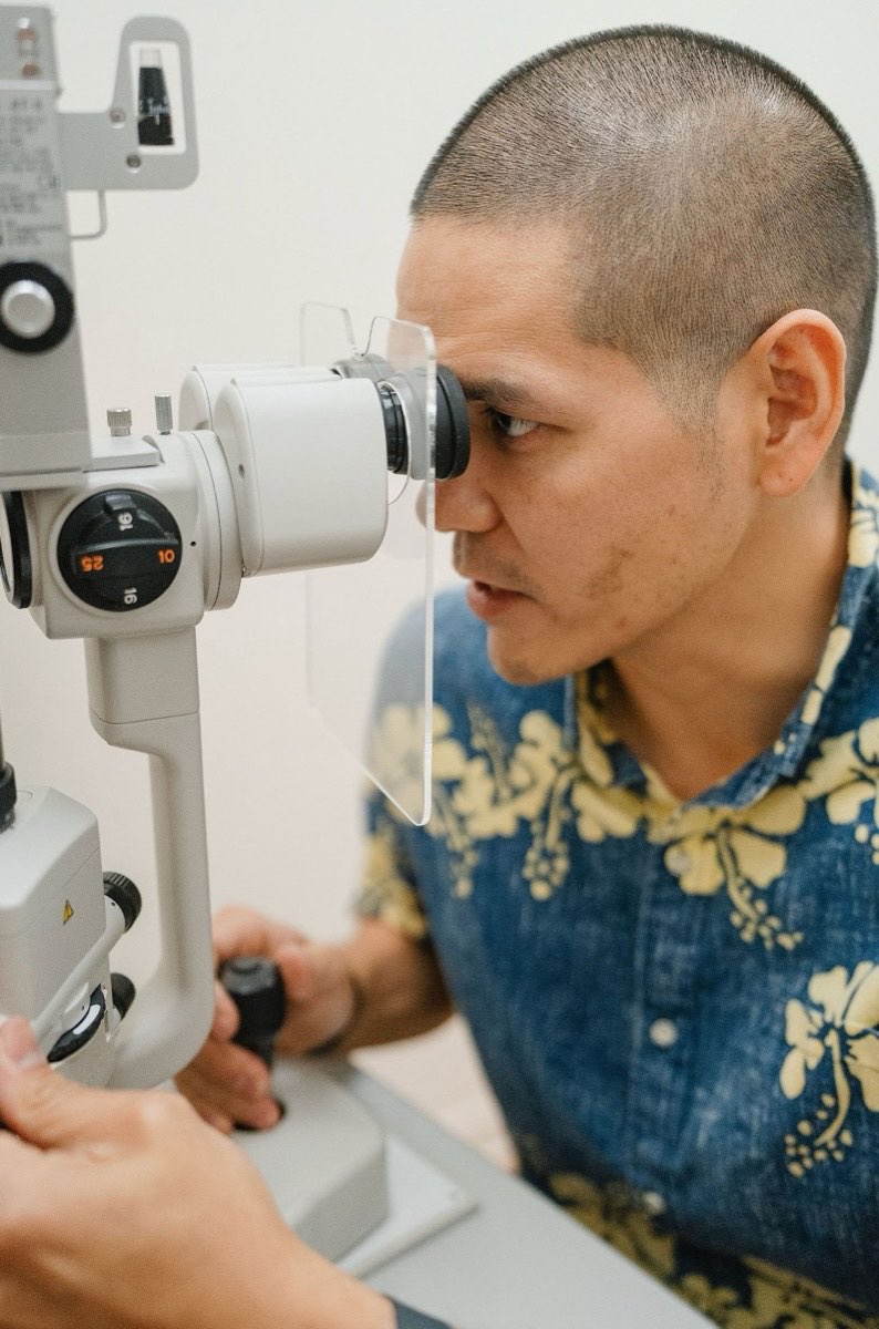 Dr. James “Jimmy” Miyasaka performing a slit lamp eye exam